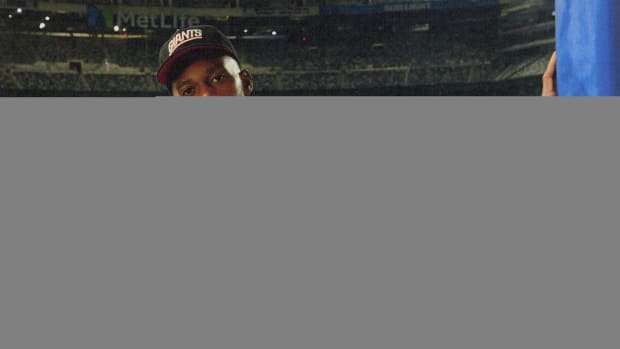 Victor Crus models New York Giants apparel.